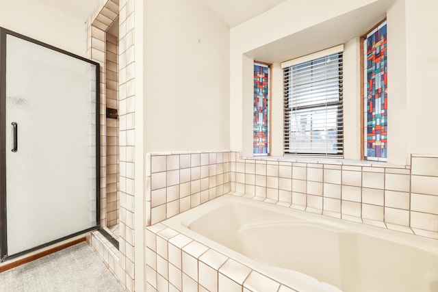 bathroom featuring independent shower and bath