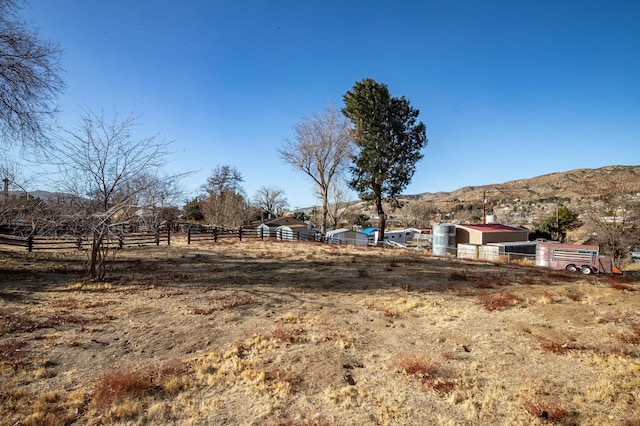 view of yard with a mountain view and a rural view