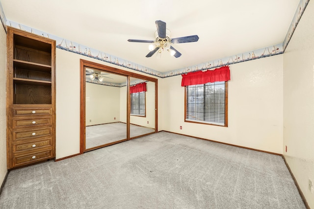 unfurnished bedroom with a closet, ceiling fan, and carpet floors