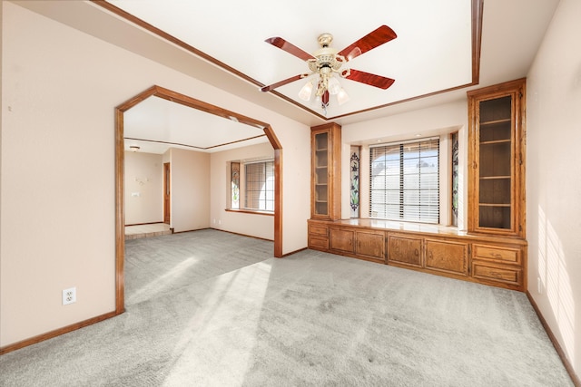 carpeted empty room featuring plenty of natural light and ceiling fan