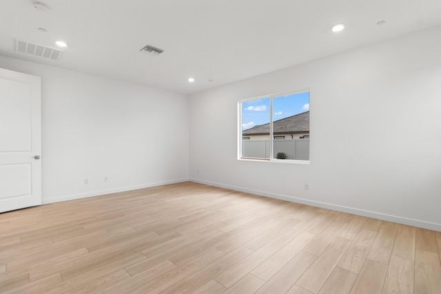 unfurnished room with light wood-style flooring, recessed lighting, visible vents, and baseboards