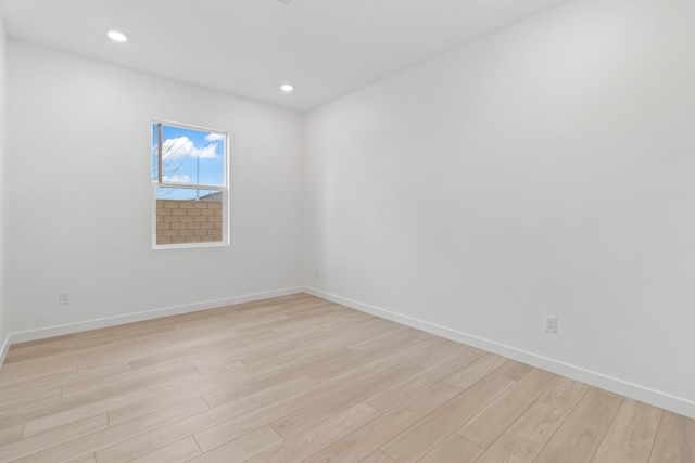 unfurnished room with recessed lighting, baseboards, and light wood-type flooring