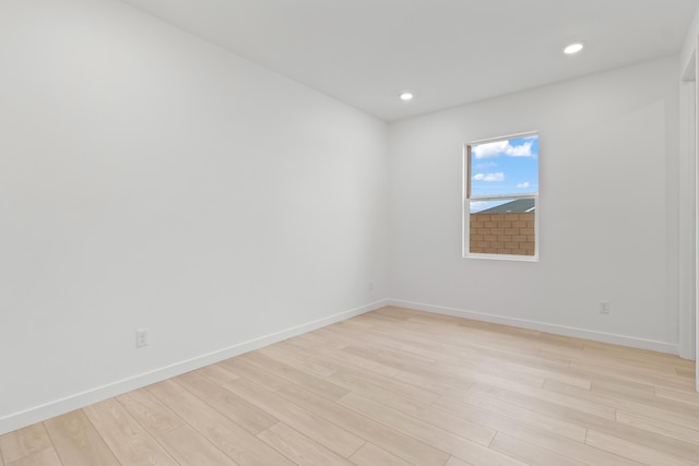 spare room with recessed lighting, baseboards, and light wood-style floors