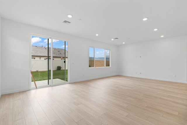 unfurnished room featuring baseboards, recessed lighting, visible vents, and light wood-type flooring