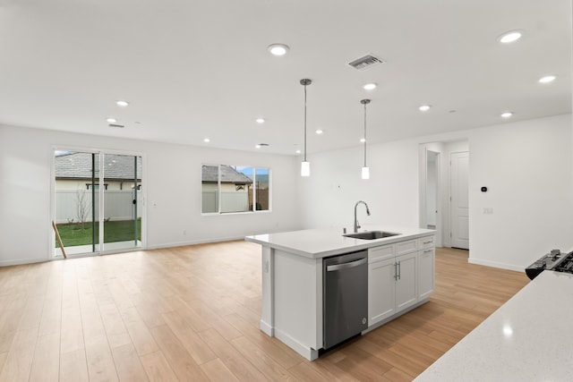 kitchen with a sink, visible vents, stainless steel dishwasher, and light wood finished floors