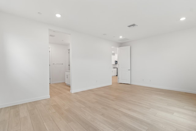 empty room with baseboards, recessed lighting, visible vents, and light wood-type flooring