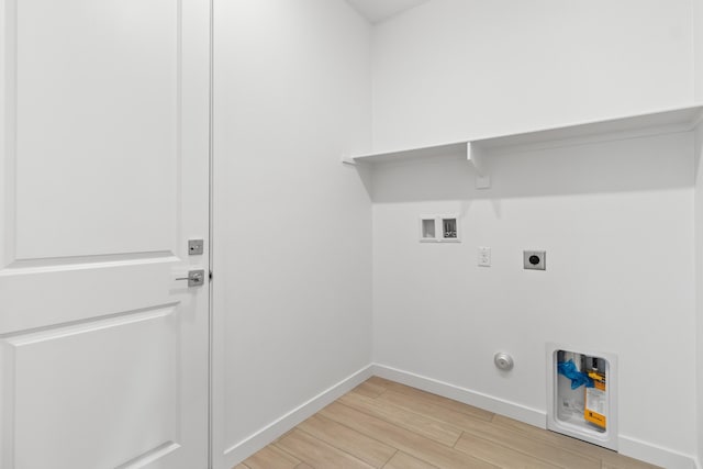 laundry room with baseboards, light wood-type flooring, laundry area, hookup for a washing machine, and hookup for an electric dryer