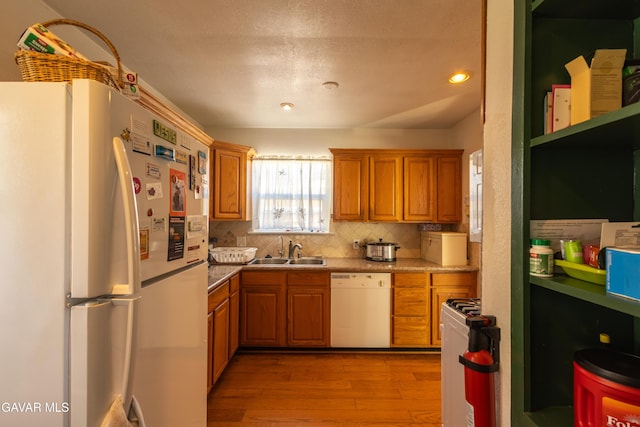 817 W J6, Lancaster, CA 93534 - kitchen featuring white appliances, light wood-type flooring, backsplash, brown cabinets, and open shelves