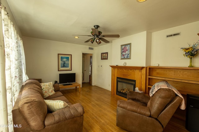 817 W J6, Lancaster, CA 93534 - living room featuring a glass covered fireplace, wood finished floors, ceiling fan, and recessed lighting