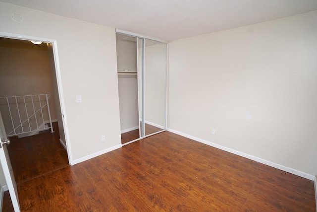 28093 Robin Ave Unit 150, Santa Clarita, CA 91350 - unfurnished bedroom with wood finished floors, baseboards, and a closet