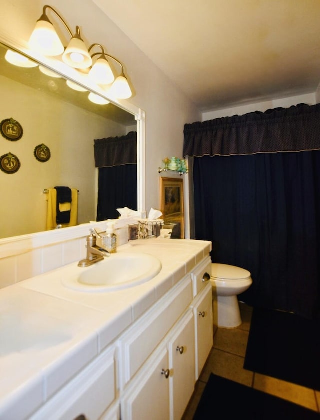 bathroom with curtained shower, tile patterned flooring, vanity, and toilet