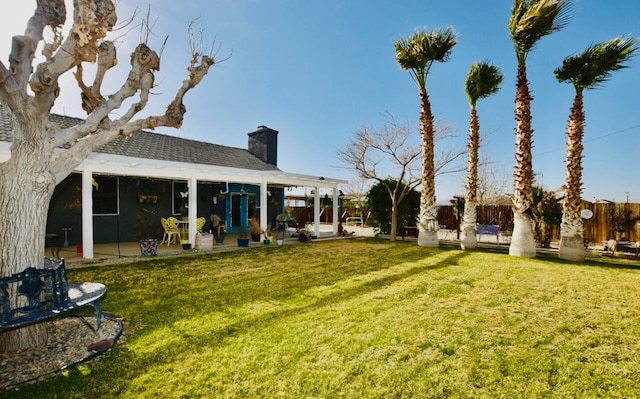 view of yard with fence and a patio