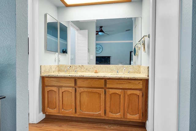 bathroom featuring hardwood / wood-style floors, vanity, and ceiling fan