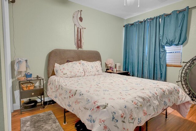 bedroom with hardwood / wood-style floors and ceiling fan