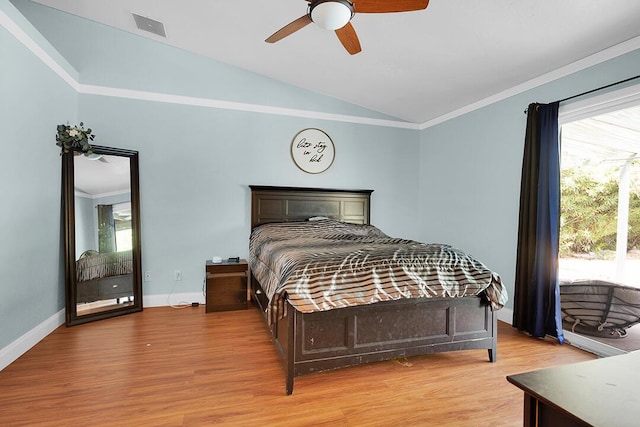 bedroom with ceiling fan, lofted ceiling, multiple windows, and light hardwood / wood-style flooring