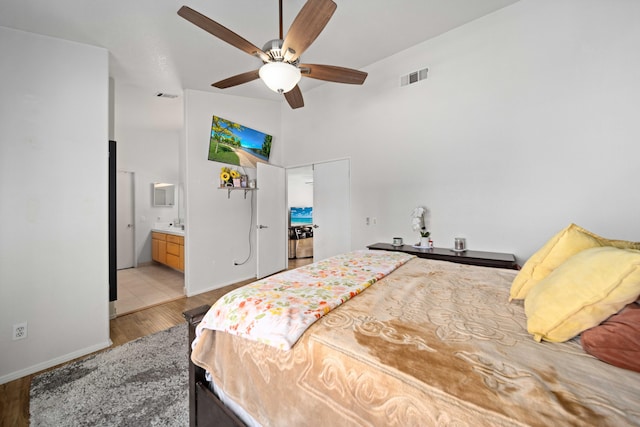 36933 Cadmia Ct, Palmdale, CA 93552 - bedroom featuring wood finished floors, a high ceiling, ensuite bathroom, a ceiling fan, and baseboards