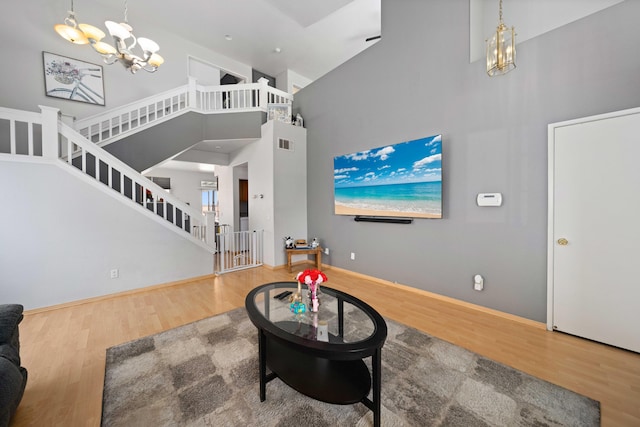 36933 Cadmia Ct, Palmdale, CA 93552 - living area featuring a chandelier, wood finished floors, stairway, and a towering ceiling