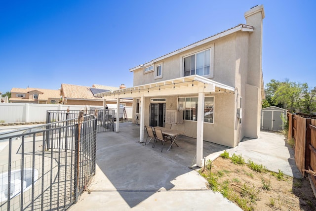 36933 Cadmia Ct, Palmdale, CA 93552 - back of property with stucco siding, a fenced backyard, a patio area, a pergola, and a chimney