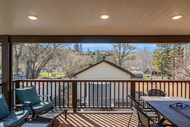 wooden deck featuring outdoor dining area