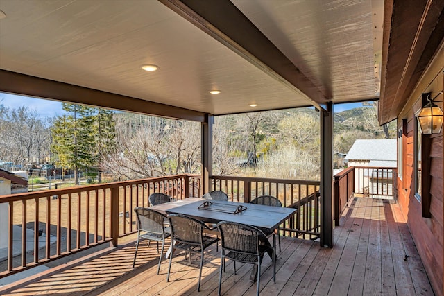 wooden deck featuring outdoor dining area