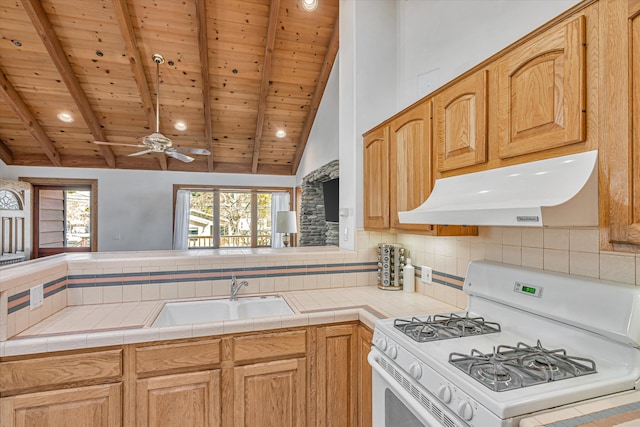 kitchen featuring lofted ceiling with beams, under cabinet range hood, white range with gas cooktop, and a sink