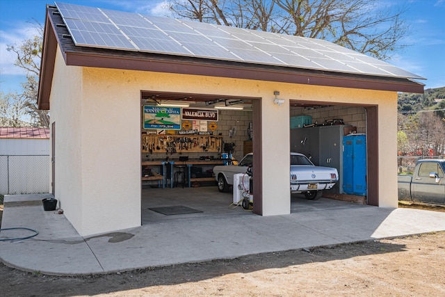 view of outbuilding featuring a garage and solar panels