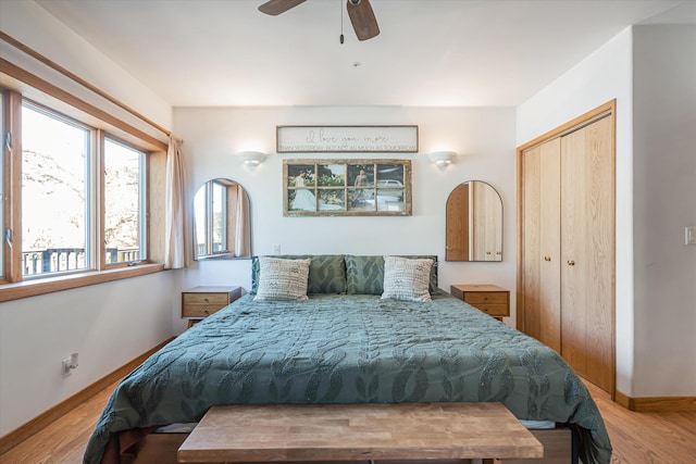 bedroom with ceiling fan, a closet, baseboards, and wood finished floors