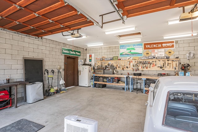 garage featuring a workshop area and a garage door opener