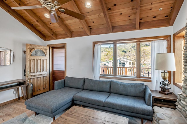 living area featuring vaulted ceiling with beams, light wood-style floors, a ceiling fan, wood ceiling, and baseboards