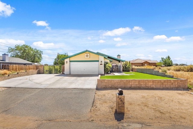 single story home featuring a garage and a front lawn