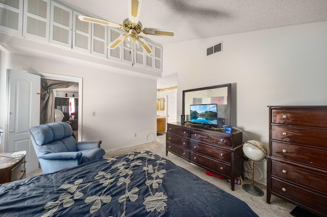 carpeted bedroom with high vaulted ceiling, ceiling fan, a textured ceiling, and connected bathroom