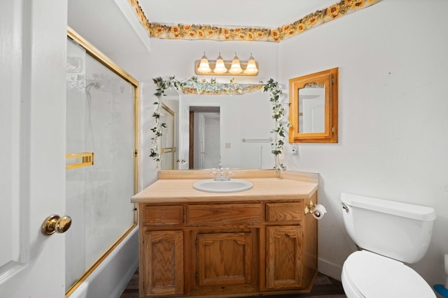 full bathroom with shower / bath combination with glass door, vanity, and toilet