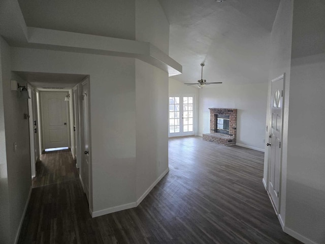 corridor with baseboards and dark wood finished floors