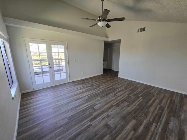 empty room with french doors, lofted ceiling, dark wood-type flooring, and baseboards