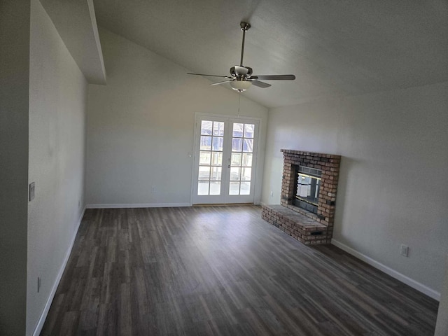 unfurnished living room with vaulted ceiling, a fireplace, baseboards, and dark wood-style flooring