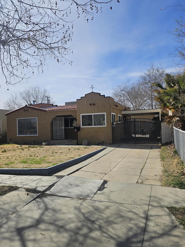 view of front facade with fence and stucco siding