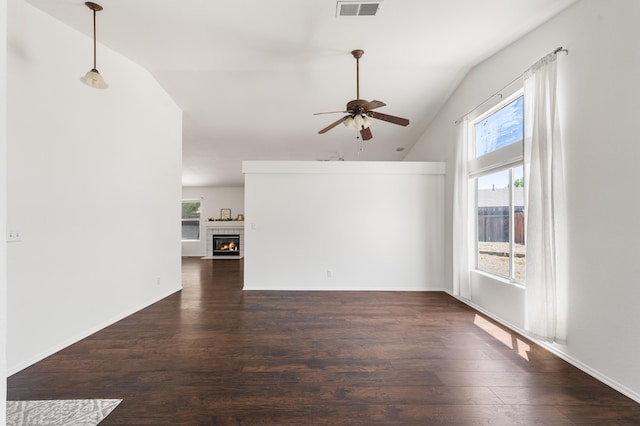 unfurnished living room with a ceiling fan, visible vents, a tile fireplace, wood finished floors, and lofted ceiling