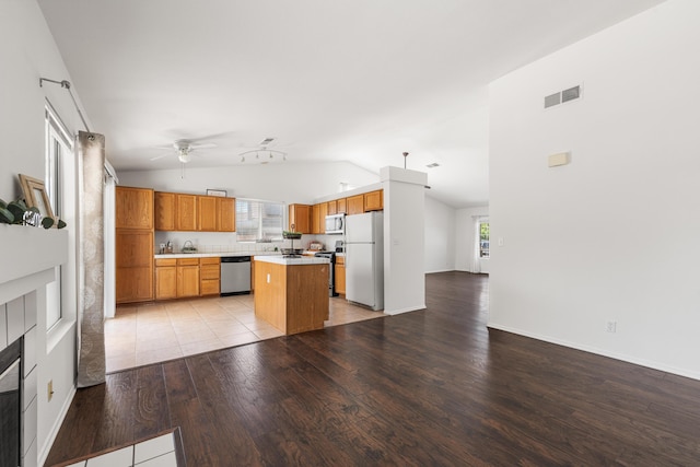 kitchen with a ceiling fan, visible vents, appliances with stainless steel finishes, lofted ceiling, and light wood-style floors