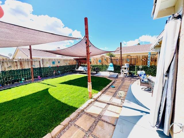 view of yard with a patio area and a fenced backyard