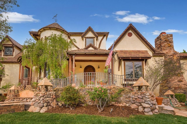 tudor house featuring stucco siding