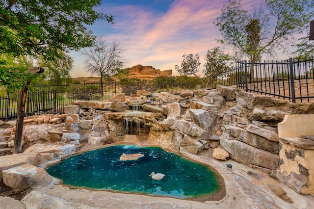 view of swimming pool featuring fence