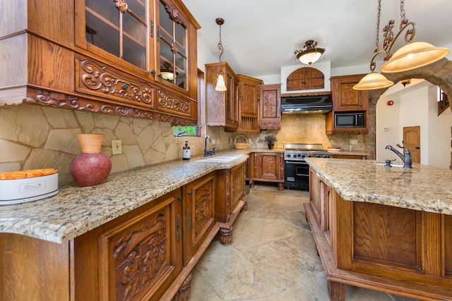 kitchen with range with gas cooktop, stone finish flooring, exhaust hood, and a sink