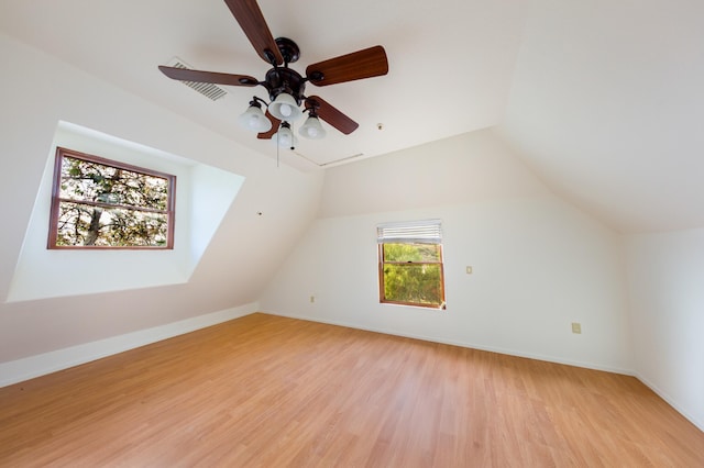 bonus room featuring lofted ceiling, a ceiling fan, light wood finished floors, and baseboards