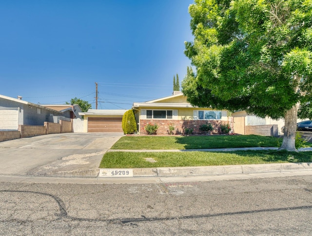 45209 Lorimer Ave, Lancaster, CA 93534 - view of front of property with concrete driveway, a garage, and brick siding