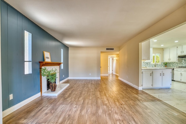 45209 Lorimer Ave, Lancaster, CA 93534 - unfurnished living room featuring light wood-style flooring and baseboards