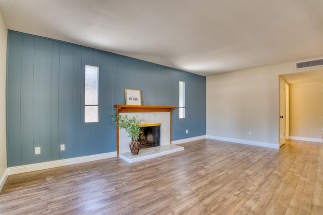 45209 Lorimer Ave, Lancaster, CA 93534 - unfurnished living room with wood finished floors, a fireplace, and baseboards