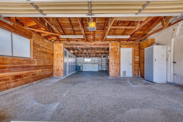 45209 Lorimer Ave, Lancaster, CA 93534 - garage with wooden walls and a garage door opener