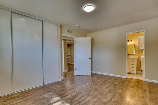45209 Lorimer Ave, Lancaster, CA 93534 - unfurnished bedroom featuring light wood-style floors, baseboards, ensuite bath, and a closet