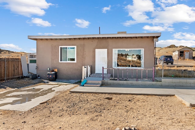 view of front of home with fence and stucco siding