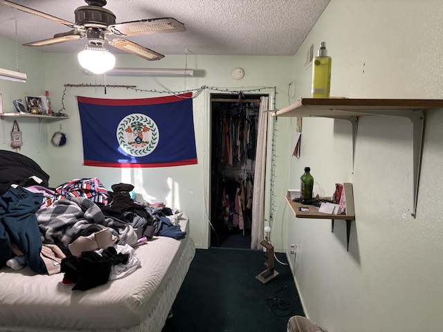 bedroom featuring ceiling fan, a closet, and a textured ceiling